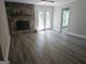 Cozy living room with a stone fireplace, hardwood floors, and natural light at 686 Favorwood Sw Dr, Marietta, GA 30060