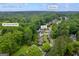 Aerial view in Kennesaw, GA, showing street views and property with a pool surrounded by lush trees at 3924 Lorien Nw Way, Kennesaw, GA 30152