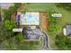 An aerial view showcasing community amenities including a pool, pool house, and playground surrounded by lush greenery at 3924 Lorien Nw Way, Kennesaw, GA 30152