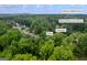 Aerial view in Kennesaw, GA, showing proximity to McClure Middle School and Bullard Elementary surrounded by lush trees at 3924 Lorien Nw Way, Kennesaw, GA 30152