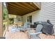 Covered back porch with stone floor has a table and chairs for entertaining at 3924 Lorien Nw Way, Kennesaw, GA 30152