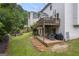 Expansive backyard with multi-level decks, a fire pit, and lush landscaping at 3924 Lorien Nw Way, Kennesaw, GA 30152
