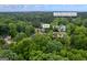 Aerial view of the backyard and fire pit in Kennesaw, GA, with lush trees and proximity to Lewis Elementary School at 3924 Lorien Nw Way, Kennesaw, GA 30152