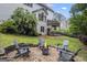 Outdoor oasis featuring a fire pit with Adirondack chairs and a lush garden at 3924 Lorien Nw Way, Kennesaw, GA 30152