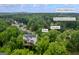 Aerial view of the exterior and deck in Kennesaw, GA, with lush trees, close to McClure Middle and Bullard Elementary Schools at 3924 Lorien Nw Way, Kennesaw, GA 30152