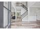 Inviting foyer featuring wood-look floors, an open staircase, and views into the living spaces at 3924 Lorien Nw Way, Kennesaw, GA 30152