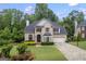 Charming brick home boasts a manicured lawn, lush landscaping, and a welcoming front entrance at 3924 Lorien Nw Way, Kennesaw, GA 30152