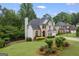 Well-maintained home showcasing a beautiful lawn, mature trees, and architectural details at 3924 Lorien Nw Way, Kennesaw, GA 30152