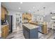 Modern kitchen with an island, stainless steel appliances, and views into the living room at 3924 Lorien Nw Way, Kennesaw, GA 30152