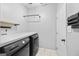 Laundry room with front loading washer and dryer, storage, and neutral tile flooring at 3924 Lorien Nw Way, Kennesaw, GA 30152
