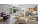 Open-concept living room with fireplace, large windows, and views to the backyard and kitchen at 3924 Lorien Nw Way, Kennesaw, GA 30152