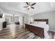 Inviting main bedroom suite with wood floors, tray ceilings, ceiling fan, and ample natural light at 3924 Lorien Nw Way, Kennesaw, GA 30152