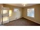 Bedroom with light beige walls and carpeted floors, and a window at 4366 Glenwood Pkwy, Decatur, GA 30032