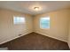 Neutral bedroom with carpet, two windows with blinds, and overhead light fixture at 4366 Glenwood Pkwy, Decatur, GA 30032