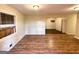 Spacious living room featuring wood-look floors, neutral paint and trim, and a large window at 4366 Glenwood Pkwy, Decatur, GA 30032
