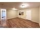 An open living room with wood floors, neutral walls and a white door at 4366 Glenwood Pkwy, Decatur, GA 30032