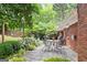 Outdoor patio with string lights, dining set and lush landscaping, perfect for entertaining at 3571 Lake Se Dr, Smyrna, GA 30082