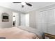 A cozy bedroom featuring a ceiling fan, neutral walls, and access to an ensuite bathroom and closet at 3571 Lake Se Dr, Smyrna, GA 30082