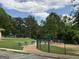 A grassy field with a baseball field, playground and picnic benches at 3571 Lake Se Dr, Smyrna, GA 30082