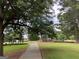 Path to covered picnic area and playground in a lush, green park with mature trees at 3571 Lake Se Dr, Smyrna, GA 30082