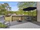 Back deck with a fire pit, outdoor seating, and an umbrella for shade at 3823 Heritage Pl, Buford, GA 30519