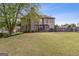 A sprawling backyard, showing the home's exterior, large lawn, and deck at 3823 Heritage Pl, Buford, GA 30519