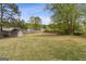 Large, level backyard featuring a storage shed and a wood privacy fence at 3823 Heritage Pl, Buford, GA 30519