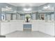 Bright bathroom featuring dual sinks, a vanity, and white cabinets under a large mirror at 3823 Heritage Pl, Buford, GA 30519