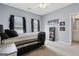 Bright bedroom with a ceiling fan, a bookshelf full of colorful books, and a view into an ensuite bathroom at 3823 Heritage Pl, Buford, GA 30519