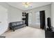 This is a bedroom or flex space with a black futon, carpet, and great natural light at 3823 Heritage Pl, Buford, GA 30519