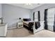 This is a cozy bedroom with light blue walls, carpet, and an accent table with a lamp at 3823 Heritage Pl, Buford, GA 30519