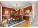 Charming dining room with a hardwood floor, an elegant chandelier, and a traditional china cabinet for storage and display at 3823 Heritage Pl, Buford, GA 30519