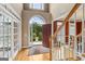 Elegant foyer with hardwood floors, a staircase and a view to the outside showcasing the home's bright and airy ambiance at 3823 Heritage Pl, Buford, GA 30519