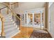 Spacious foyer featuring hardwood floors, a staircase, and double doors leading to another room at 3823 Heritage Pl, Buford, GA 30519