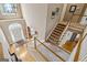 Bright two-story foyer with hardwood floors, staircase, and a view of the entry door at 3823 Heritage Pl, Buford, GA 30519
