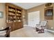 Cozy home office features a built-in wooden bookshelf and a comfortable rocking chair at 3823 Heritage Pl, Buford, GA 30519