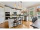 Charming kitchen with stainless steel appliances, black countertops, and a window at 3823 Heritage Pl, Buford, GA 30519
