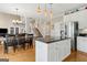 Bright kitchen with stainless steel appliances, black countertops, and a dining area at 3823 Heritage Pl, Buford, GA 30519