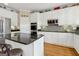 Open kitchen with stainless steel appliances, granite counters and center island with bar seating at 3823 Heritage Pl, Buford, GA 30519