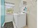 Well-lit laundry room with modern washer and dryer and functional shelving at 3823 Heritage Pl, Buford, GA 30519