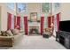 Comfortable living room features a fireplace, large windows, and red curtains at 3823 Heritage Pl, Buford, GA 30519