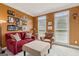 Cozy living room with a red couch, colorful armchair, and bright paint at 3823 Heritage Pl, Buford, GA 30519