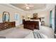 Large main bedroom with furniture set, a trey ceiling, lamps, and access to the bathroom at 3823 Heritage Pl, Buford, GA 30519