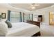 Bright main bedroom with large bed, windows, and cozy sitting area perfect for relaxation at 3823 Heritage Pl, Buford, GA 30519