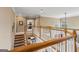 Bright upper landing overlooking kitchen and dining area with hardwood banister at 3823 Heritage Pl, Buford, GA 30519