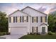 Charming two-story home with a two-car garage, green shutters, and beautiful landscaping at 4576 Sunrise Rdg, Covington, GA 30016