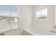Bright white soaking tub situated beneath a window, filling the bathroom with natural light at 1940 Van Allen Ct # 12, Dacula, GA 30019
