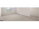Unfurnished bedroom showcasing neutral carpeting and a bright window at 1940 Van Allen Ct # 12, Dacula, GA 30019