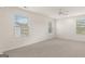 Bright and airy bedroom with neutral carpet, ceiling fan, and good light from the windows at 1940 Van Allen Ct # 12, Dacula, GA 30019