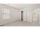 Well-lit bedroom with closet, neutral walls, and plush carpeting at 1940 Van Allen Ct # 12, Dacula, GA 30019